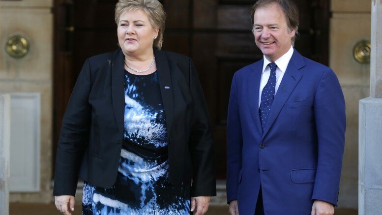 Norway's Prime Minister Erna Solberg (L) is met by Britain's Foreign Office minister Hugo Swire