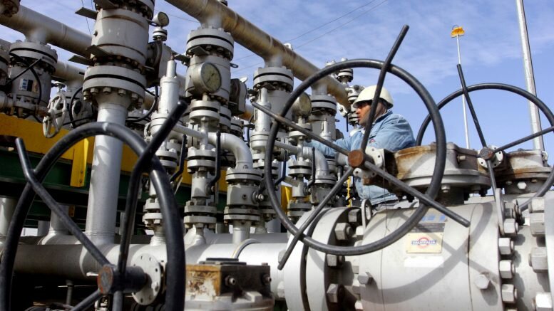 A worker checks the valves at Al-Sheiba oil refinery in the city of Basra, Iraq