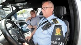 50/5000 Prime Minister Erna Solberg is sitting on a police car
