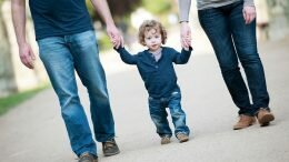 Little boy walks with mother and father