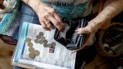 Older lady with coins and wallet.