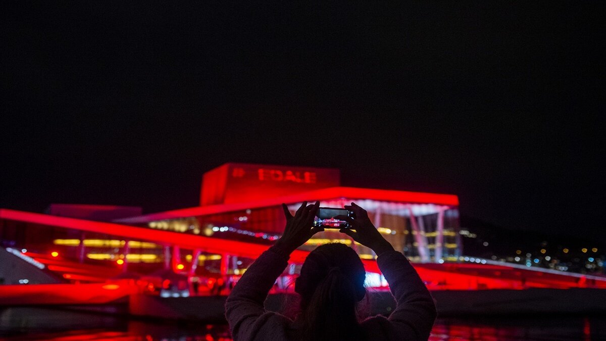 Several buildings lit up in red to draw attention to Norway’s struggling culture industry